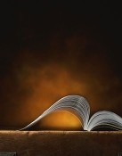 Image of an open textbook against a dark backdrop