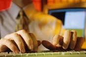 Image of a man typing on a keyboard