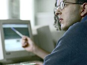 Image of adult learners studying near a computer